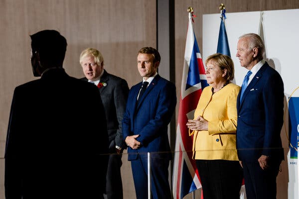 President Biden with Chancellor Angela Merkel of Germany, President Emmanuel Macron of France and Prime Minister Boris Johnson of Britain at the G20 summit on Saturday in Rome.