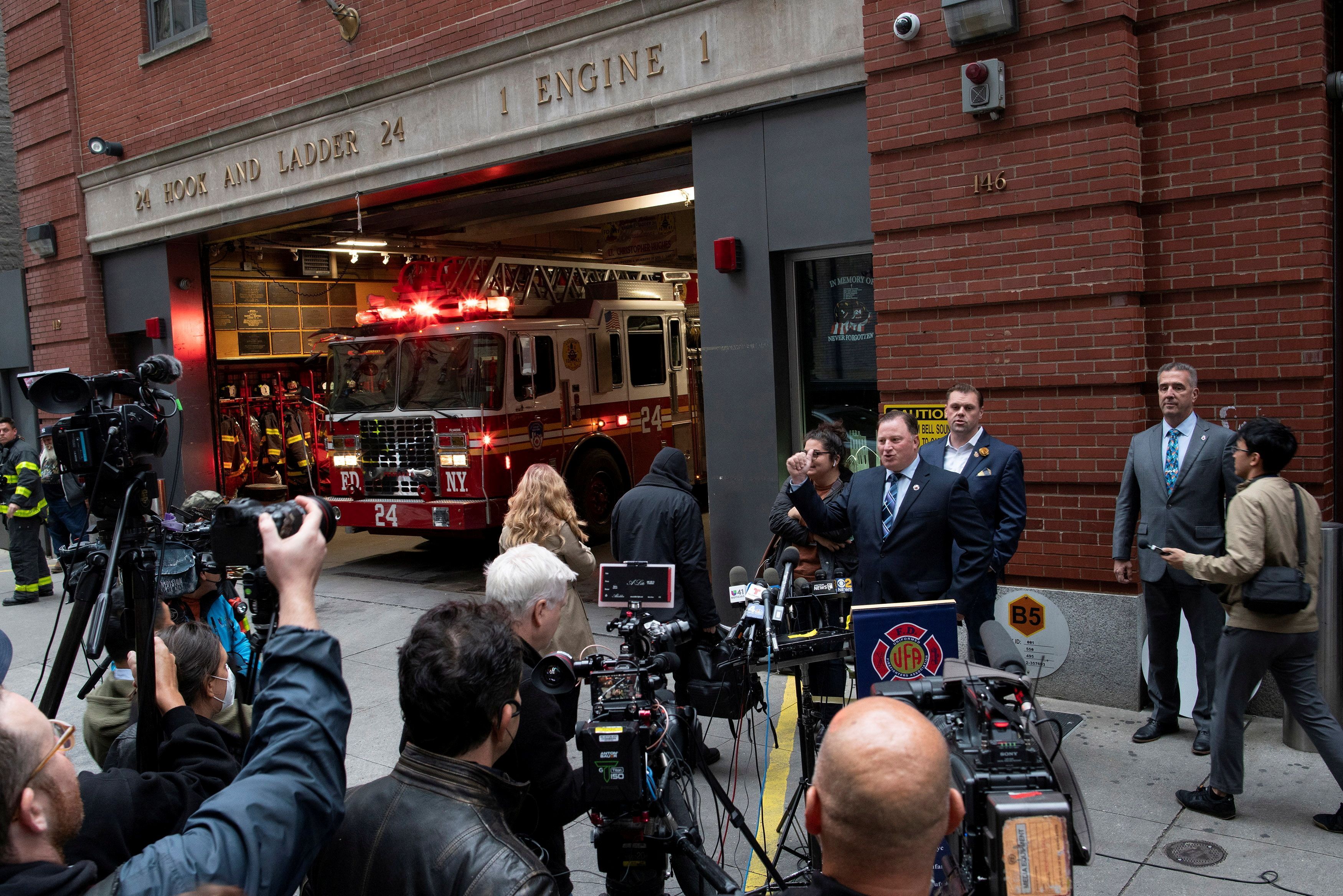 New York City Fire Department (FDNY) Uniformed Firefighters Association (UFA) President Andrew Ansbro speaks while a NYFD truck exit the building during a news conference as the city's COVID-19 vaccine mandate deadline approaches at Ladder Co. 24 in Manhattan, New York City, New York, U.S., October 29, 2021. REUTERS/Eduardo Munoz/File Photo